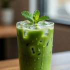 Iced matcha drink in a tall glass with fresh mint garnish